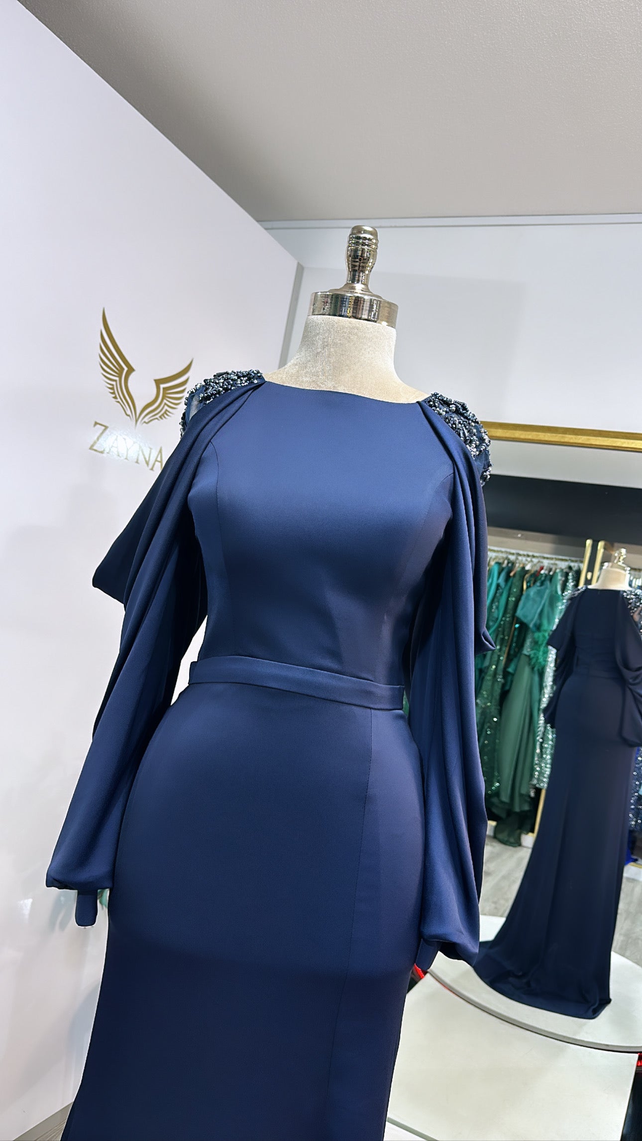 Amazing dark blue dress decorated with beads at the sleeves, split