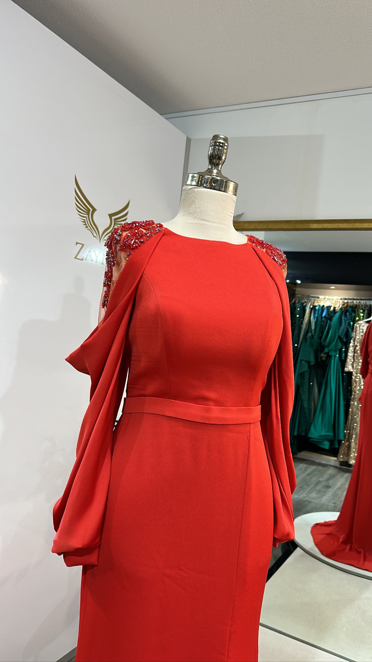 Elegant orange dress decorated with sleeves, split