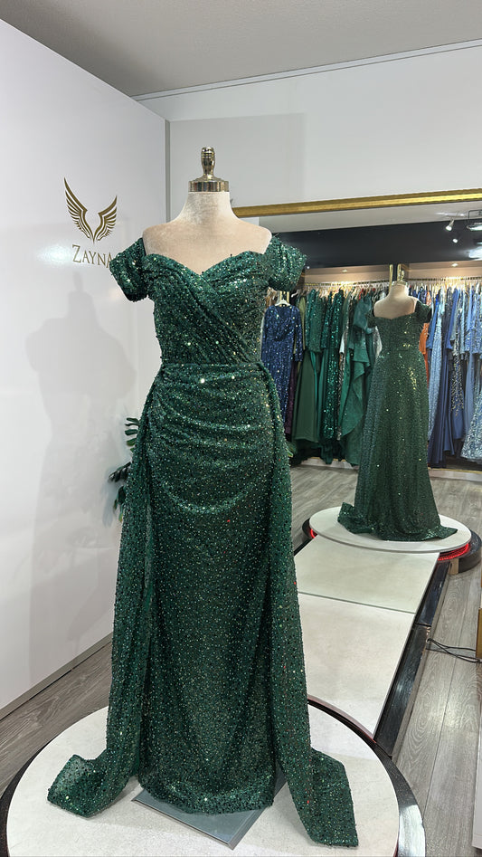 Elegant green dress decorated with beads, train, on the shoulder