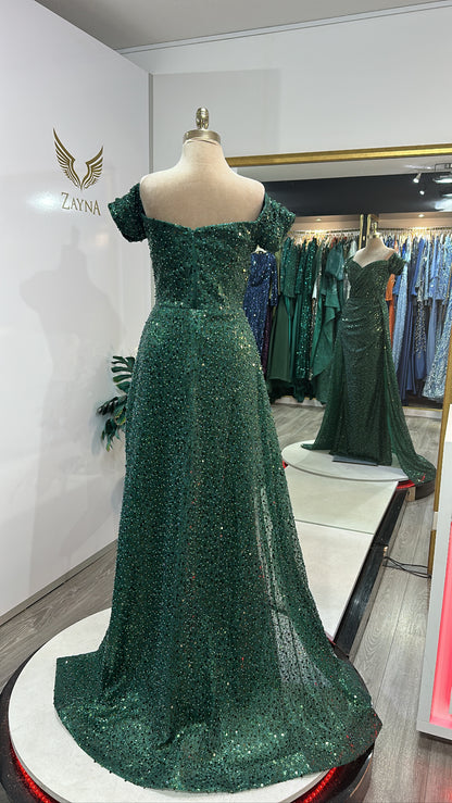Elegant green dress decorated with beads, train, on the shoulder