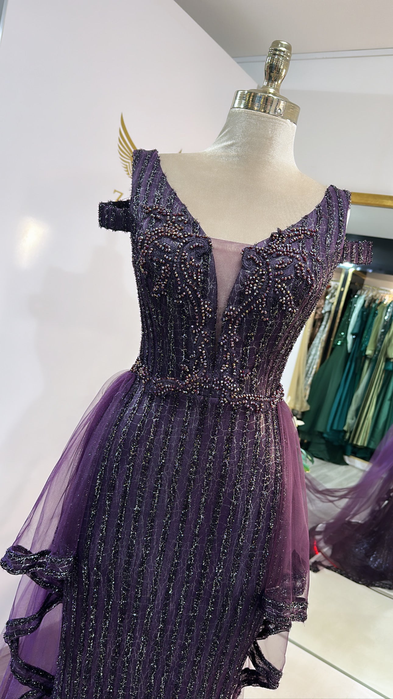 Elegant purple dress design, decorated with beads, tulle train