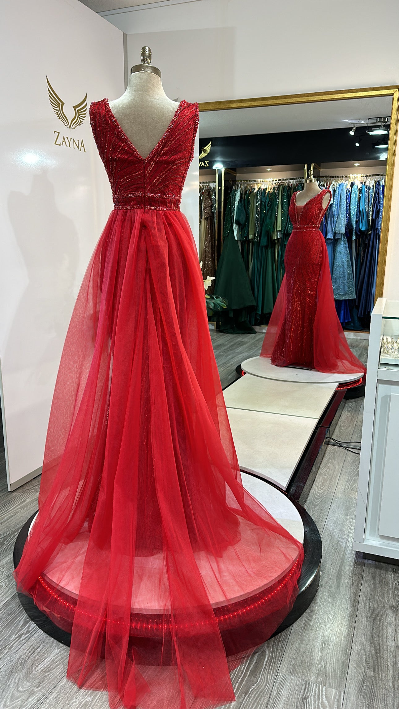 Elegant red dress with train, decorated with beads