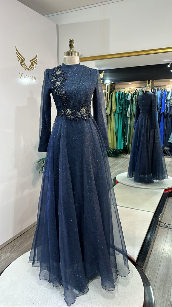 Elegant dark blue dress decorated with beads, shiny